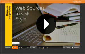 Screenshot of the Digital Writer's Reference for Pearson Education. Applicatin shows a photo of a laptop and a notepad with a video play button. A sidebar shows the title of the video.