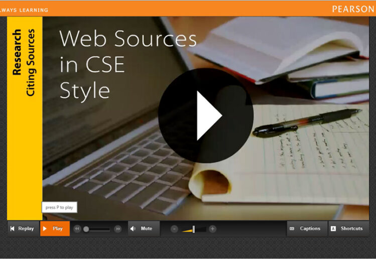 Screenshot of the Digital Writer's Reference for Pearson Education. Applicatin shows a photo of a laptop and a notepad with a video play button. A sidebar shows the title of the video.